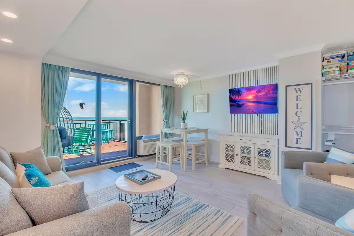Bright coastal living room with ocean-view balcony