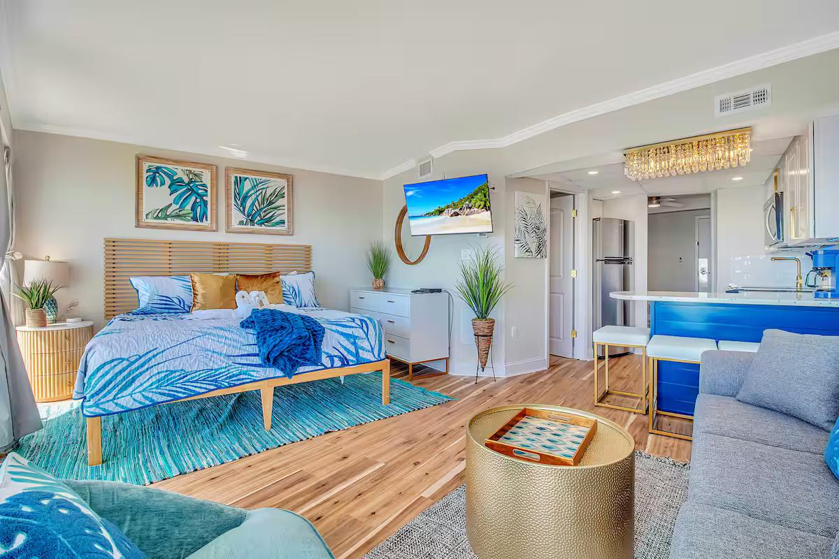 Coastal studio suite with palm-print styling and kitchenette